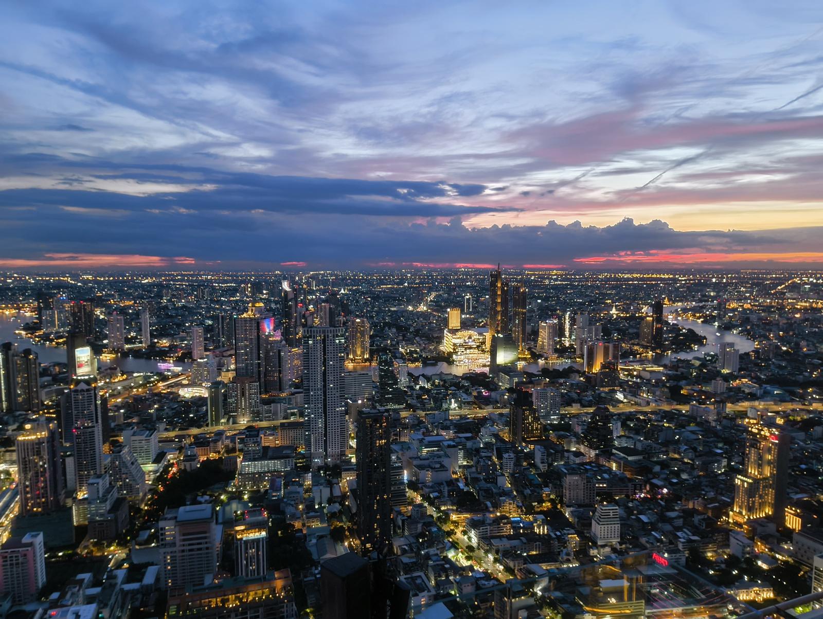 An evening aerial view of the vibrant Bangkok skyline, a key setting for many reality tv productions in Thailand.
